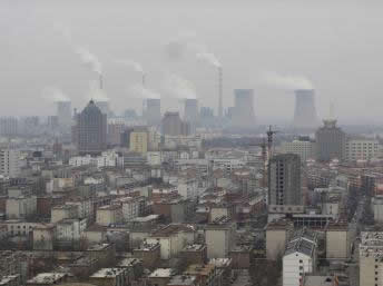 smoke rises from chimneys on a hazy day in Dezhou, Shandong province, China